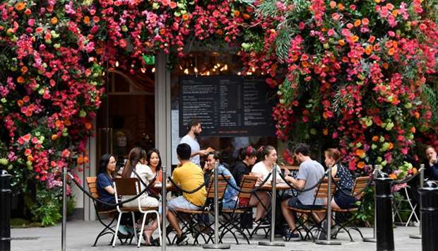 People dine at a cafe in the Covent Garden shopping and dining district, amid the spread of coronavirus, in London yesterday.