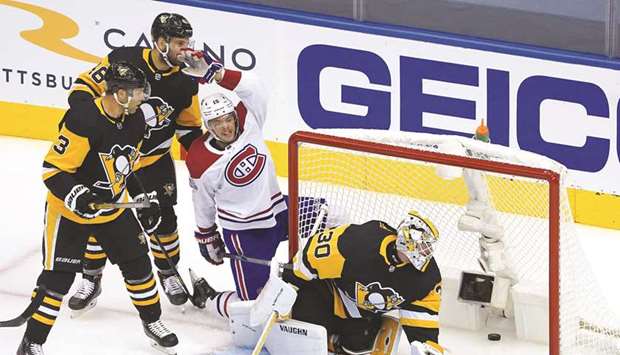 Jesperi Kotkaniemi of the Montreal Canadiens celebrates his goal as Matt Murray of the Pittsburgh Penguins looks at the puck in Game One of the Eastern Conference Qualification Round prior to the 2020 NHL Stanley Cup Playoffs at Scotiabank Arena on Saturday.