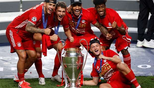 Bayern Munich French players (L-R) Bayern Munich's French defender Lucas Hernandez, Bayern Munich's French defender Benjamin Pavard, Bayern Munich's French midfielder Corentin Tolisso, Bayern Munich's French forward Kingsley Coman and Bayern Munich's French midfielder Michael Cuisance celebrate with the trophy after the UEFA Champions League final football match between Paris Saint-Germain and Bayern Munich at the Luz stadium in Lisbon