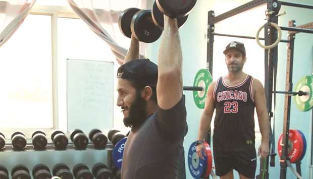 Sheikh Fahad bin Khalid al-Thani trains under the watchful eyes of Franck Bohec (right) at a Doha gym.
