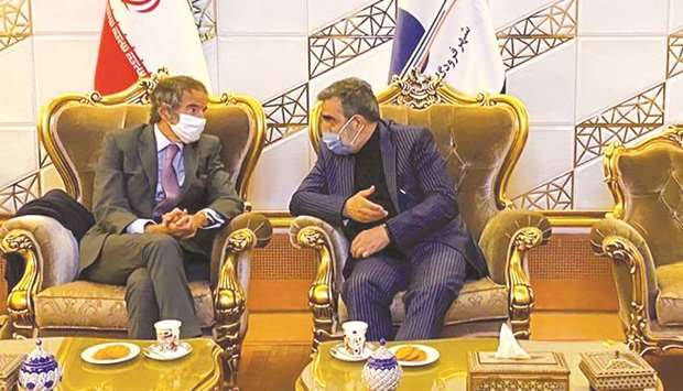 Iranu2019s Atomic Energy Organisation spokesman Behrouz Kamalvandi (right) speaks with IAEA chief Rafael Mariano Grossi at the Imam Khomeini International airport in Tehran.