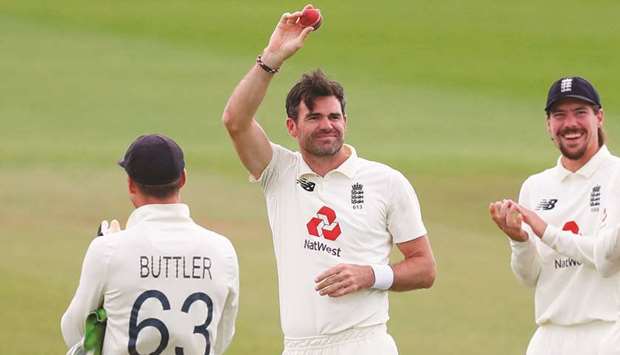 Englandu2019s James Anderson (C) shows the ball as he is applauded by teammates after taking the wicket of Pakistanu2019s Azhar Ali, his 600th Test match wicket, on the fifth day of the third Test match at the Ageas Bowl in Southampton yesterday.