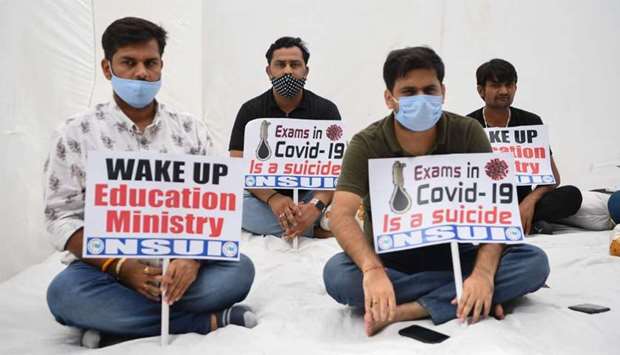 Activists of the National Students Union of India (NSUI ) take part in a demonstration demanding postponement of JEE and NEET, two of India's most competitive entrance exams for entry to top engineering and medical colleges, in New Delhi on Wednesday.