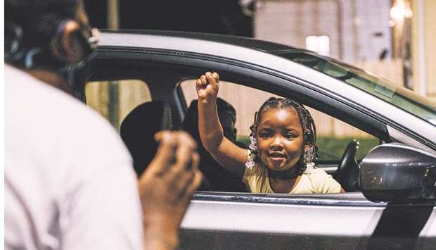 Four-year-old Lasiya Lakes and her grandmother practice raising their fists in the air and chanting Black Lives Matter in Kenosha, Wisconsin.