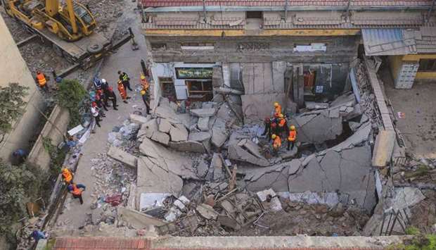 This aerial view taken yesterday shows rescuers searching through the rubble of a collapsed restaurant in Linfen, in Chinau2019s northern Shanxi province.