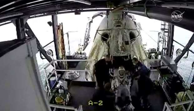 An opened hatch of the capsule carrying NASA astronauts is seen as one of the astronauts exits it in the Gulf of Mexico, yesterday, in this still image taken from a video.