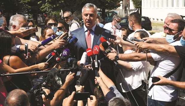 Djukanovic addresses the media in front of a polling station in the capital Podgorica.