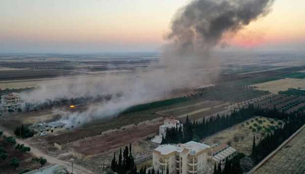 Smoke billows following airstrikes and shelling on the town of Binnish in Syria's jihadist-controlled northwestern Idlib province
