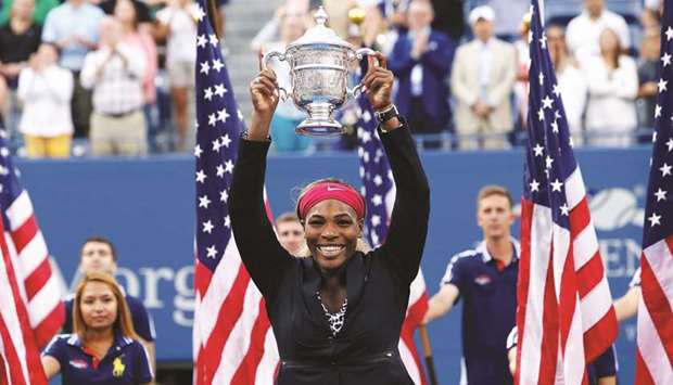File photo of Serena Williams of the US raising her trophy after defeating Caroline Wozniacki of Denmark in the final of the 2014 US Open. Serena is hoping to equal Margaret Courtu2019s record of 24 Grand Slam singles titles at this yearu2019s event beginning today.