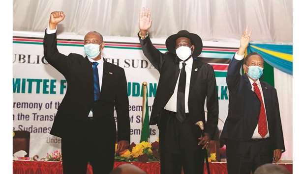Chairman of the Transitional Military Council of Sudan Abdel Fattah (left) and South Sudan President Salva Kiir (second left) greet people during the singing of the Sudan peace deal with the rebels groups in Juba, South Sudan, yesterday.