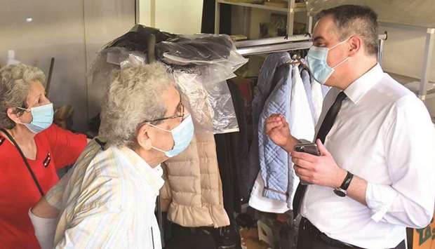 Lebanonu2019s newly-appointed Prime Minister Mustapha Adib (right) speaks with the owners of a damaged shop during a tour in Beirutu2019s badly-hit Gemmayzeh neighbourhood, yesterday.