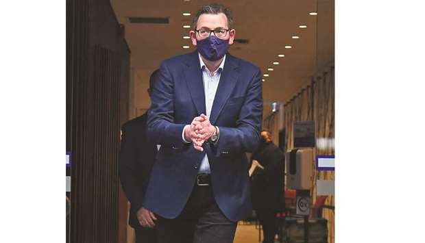 Victoriau2019s state premier Daniel Andrews sanitises his hands as he leaves a press conference in Melbourne yesterday after announcing new restrictions to curb the spread of the coronavirus.