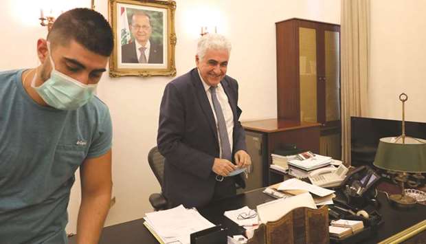 Lebanonu2019s Foreign Minister Nassif Hitti (right) is pictured in his office in the capital Beirut, yesterday.