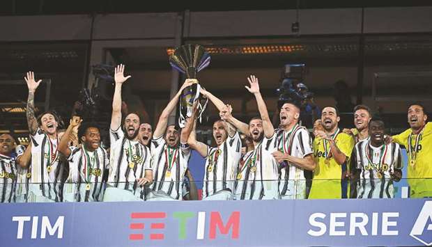 Juventus players celebrate being crowned champions at the end of the Serie A match against Roma on Saturday at the Allianz stadium in Turin, Italy. (AFP)