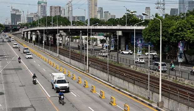 Motorists travel on a usually busy highway during a new round of lockdown measures for the COVID-19 coronavirus outbreak in Manila