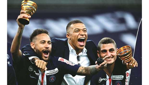 Paris Saint-Germainu2019s Neymar (left), Kylian Mbappe (centre) and Marco Verratti celebrate after winning the Coupe de la Ligue on Friday. (AFP)