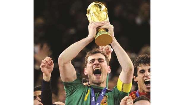 In this file photo taken on July 11, 2010 Spainu2019s goalkeeper Iker Casillas celebrates with the trophy following the 2010 World Cup football final against the Netherlands at Soccer City stadium in Soweto, suburban Johannesburg.