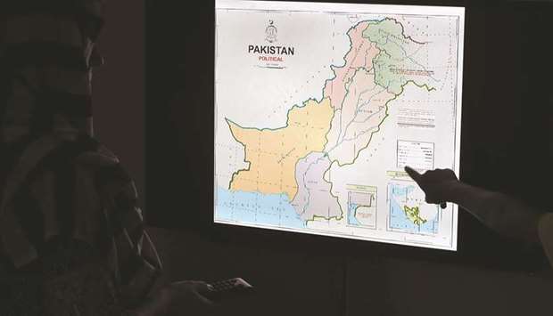 Journalists look at Pakistanu2019s new political map on a screen at the Daily Metro Watch newspaper offices in Islamabad yesterday.