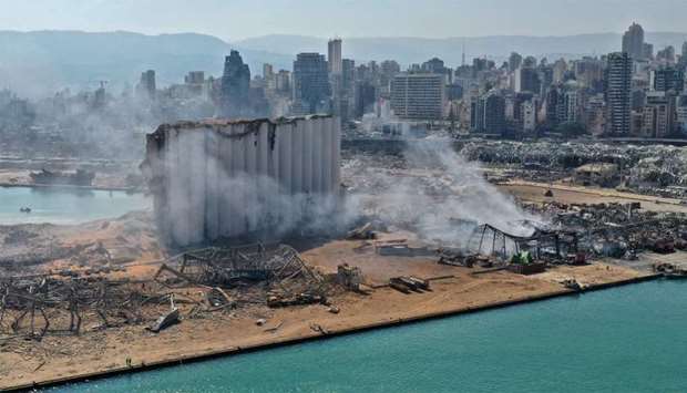 An aerial view shows the massive damage done to Beirut port's grain silos (C) and the area around it, one day after a mega-blast tore through the harbour in the heart of the Lebanese capital