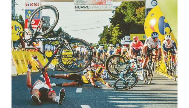 Dutch cyclist Dylan Groenewegen (on the ground, centre) and fellow riders collide during the opening stage of the Tour of Poland race in Katowice, southern Poland on Wednesday. (AFP)