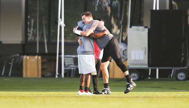 Tampa Bay Buccaneers running back LeSean McCoy (left) gets a hug from quarterback Tom Brady while attending Bucs training camp on August 4, 2020, at the AdventHealth Training Center in Tampa, Florida. (Tampa Bay Times/TNS)