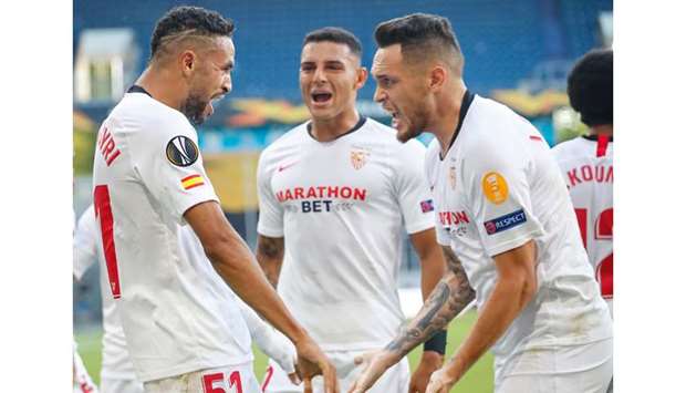 Sevillau2019s Youssef En-Nesyri (left) celebrates with teammate Lucas Ocampos (right) after scoring against Roma during the Europa League round of 16 match in Duisburg. (AFP)