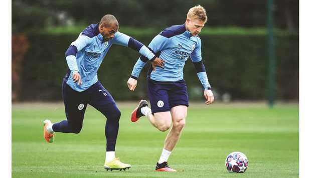 Manchester Cityu2019s Kevin De Bruyne (right) and Fernandinho train in Manchester yesterday.