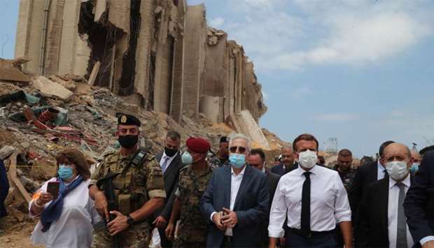 French President Emmanuel Macron and Foreign Minister Jean-Yves Le Drian inspect the damages at the port of Beirut