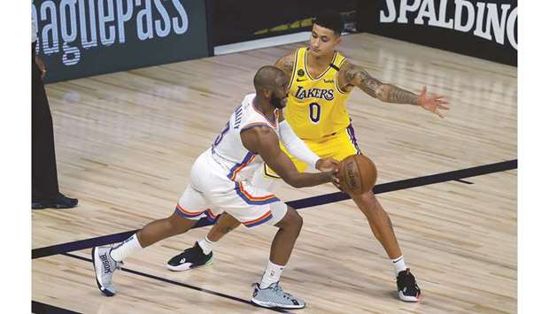 Kyle Kuzma of the Los Angeles Lakers defends Chris Paul of the Oklahoma City Thunder during the third quarter at HP Field House at ESPN Wide World Of Sports Complex at the Lake Buena Vista, Florida. (USA TODAY Sports)