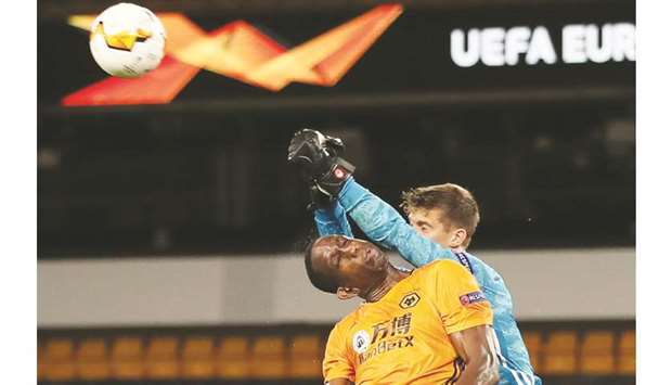 Wolverhamptonu2019 Willy Boly (left) and Olympiacosu2019 goalkeeper Bobby Allain vie for the ball during the Europa League last 16 match at Molineux Stadium in Wolverhampton, Britain. (Reuters)