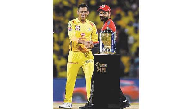 In this March 24, 2019, picture, Chennai Super Kings captain Mahendra Singh Dhoni and Royal Challengers Bangalore captain Virat Kohli (right) shake hands beside the IPL trophy in Chennai. Dhoni is among the stars who credit Sheesh Mahal tournament in Lucknow for their success. (AFP)