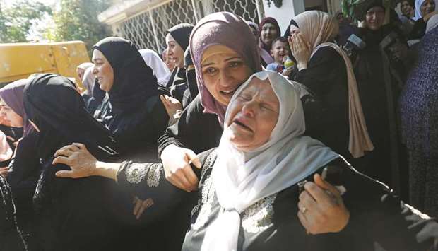 Relatives of Palestinian woman Dalia Samudi, 23, mourn during her funeral in Jenin in the occupied West Bank, yesterday.