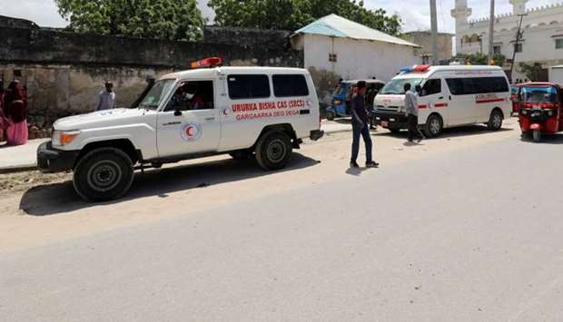 An ambulance is seen near a blast site that rocked a military base in Mogadishu, Somalia