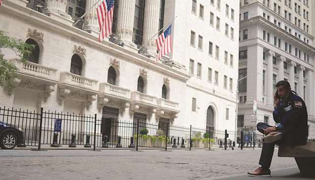 A trader makes a phone call outside the New York Stock Exchange (file). As the S&P 500 approaches fresh highs, some investors hope to pick up bargains in the battered US real estate sector, where values of some major stocks have been cut in half this year.