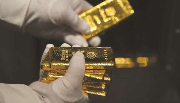 An employee holds gold bars in the precious metals vault at Pro Aurum KG in Munich. Goldu2019s surge to an all-time high is winning over a wider fan base of pension funds, insurance companies and private wealth specialists.