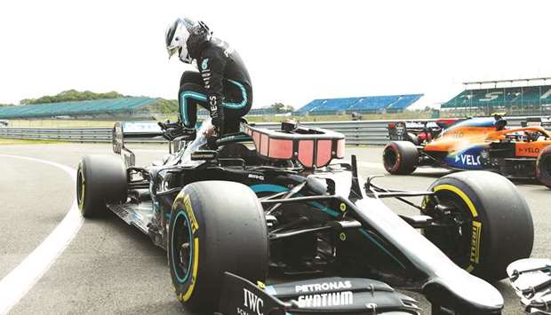 Mercedesu2019 Valtteri Bottas celebrates as he gets out of his car after qualifying in pole position yesterday.