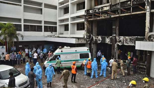 Rescue workers look for survivors after a fire broke out in a hotel that was being used as a coronavirus disease (Covid-19) facility in Vijayawada, in the southern state of Andhra Pradesh, India
