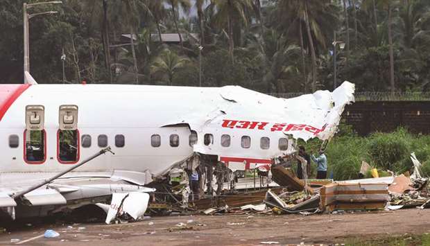 Officials inspect the site where a passenger plane crashed when it overshot the runway at the Calicut International Airport in Karipur, in the southern state of Kerala, yesterday.