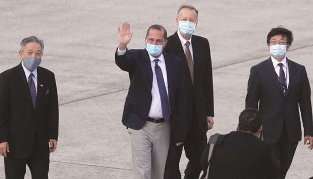 US Health Secretary Alex Azar waves to the journalists as he arrives at Sungshan Airport in Taipei yesterday.