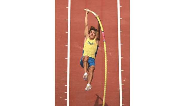 Swedenu2019s Armand Duplantis competes in the menu2019s pole vault qualification during the Tokyo 2020 Olympic Games at the Olympic Stadium in Tokyo yesterday. (AFP)