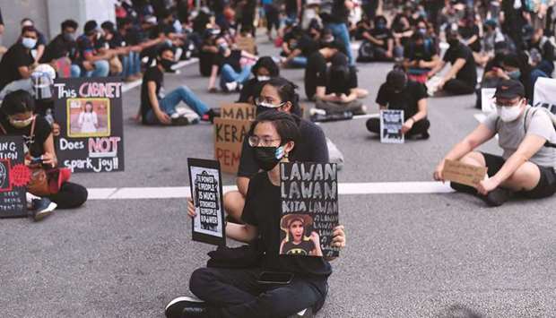 Malaysians take part in a rare anti-government rally in Kuala Lumpur yesterday despite a tough Covid-19 lockdown in place restricting gatherings and public assemblies.