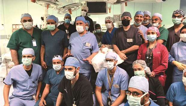 A handout picture provided by the King Salman Humanitarian Aid and Relief Center yesterday shows surgeons posing for a group photo after the successful operation.