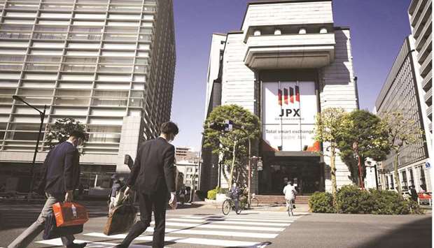 Pedestrians cross a road in front of the Tokyo Stock Exchange. The Nikkei 225 closed up 0.7% to 28,707.51 points yesterday.