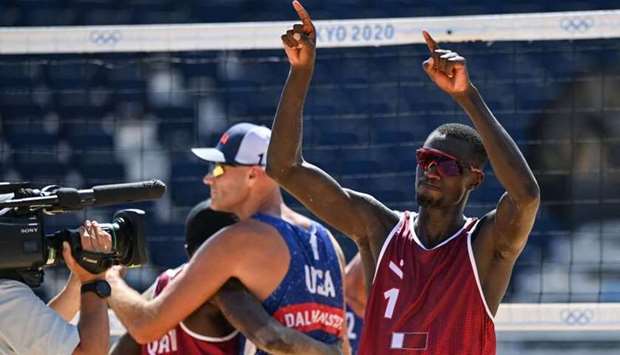 Qatar's Cherif Younousse (R) gestures, as USA's Philip Dalhausser (C) congratulates partner Qatar's Ahmed Tijan, after their men's beach volleyball round of 16 match between Qatar and the USA during the Tokyo 2020 Olympic Games at Shiokaze Park in Tokyo.  Angela WEISS / AFP)