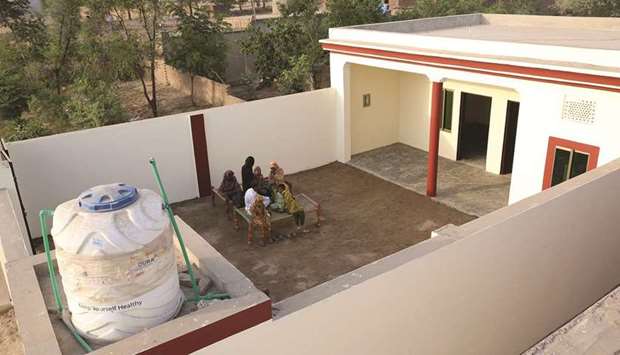 The houses include two bedrooms, a corridor, a kitchen, a toilet, a washroom, a courtyard, a cloth washing area, and a motorised water pump.