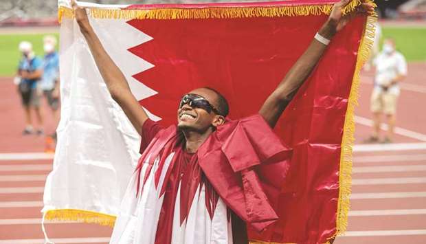 Qatar's Mutaz Essa Barshim celebrates after winning gold in the men's high jump event at the Tokyo Olympics at the Olympic Stadium on Sunday.