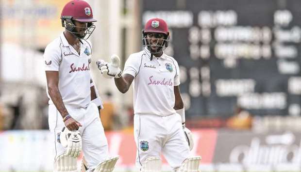 Kraigg Brathwaite (left) and Jermaine Blackwood of West Indies walk off the field for the lunch break during Day 2 of the 1st Test against Pakistan at Sabina Park, Kingston, Jamaica, yesterday. (AFP)