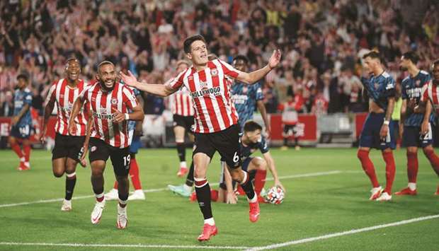 Brentfordu2019s Christian Norgaard (centre) celebrates after scoring the teamu2019s second goal during the Premier League match against Arsenal at Brentford Community Stadium in London, England, yesterday. (Reuters)