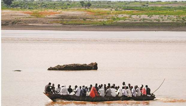 A boat sails along the Setit river bordering Ethiopia, at Wad al-Hiliou, a village in the eastern Sudanese state of Kassala. (AFP)