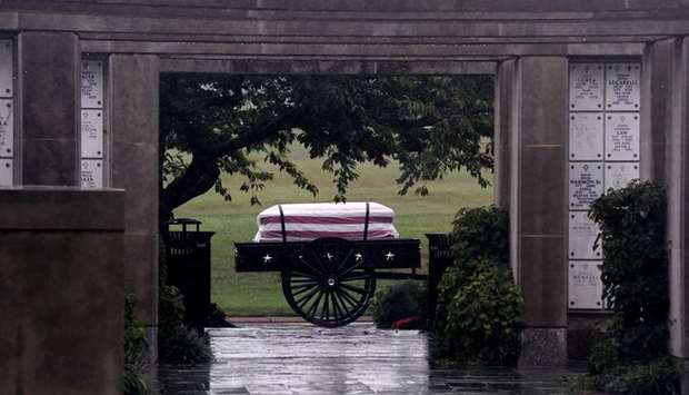 The casket of a US soldier is seen through a doorway during a full military honors burial ceremony.